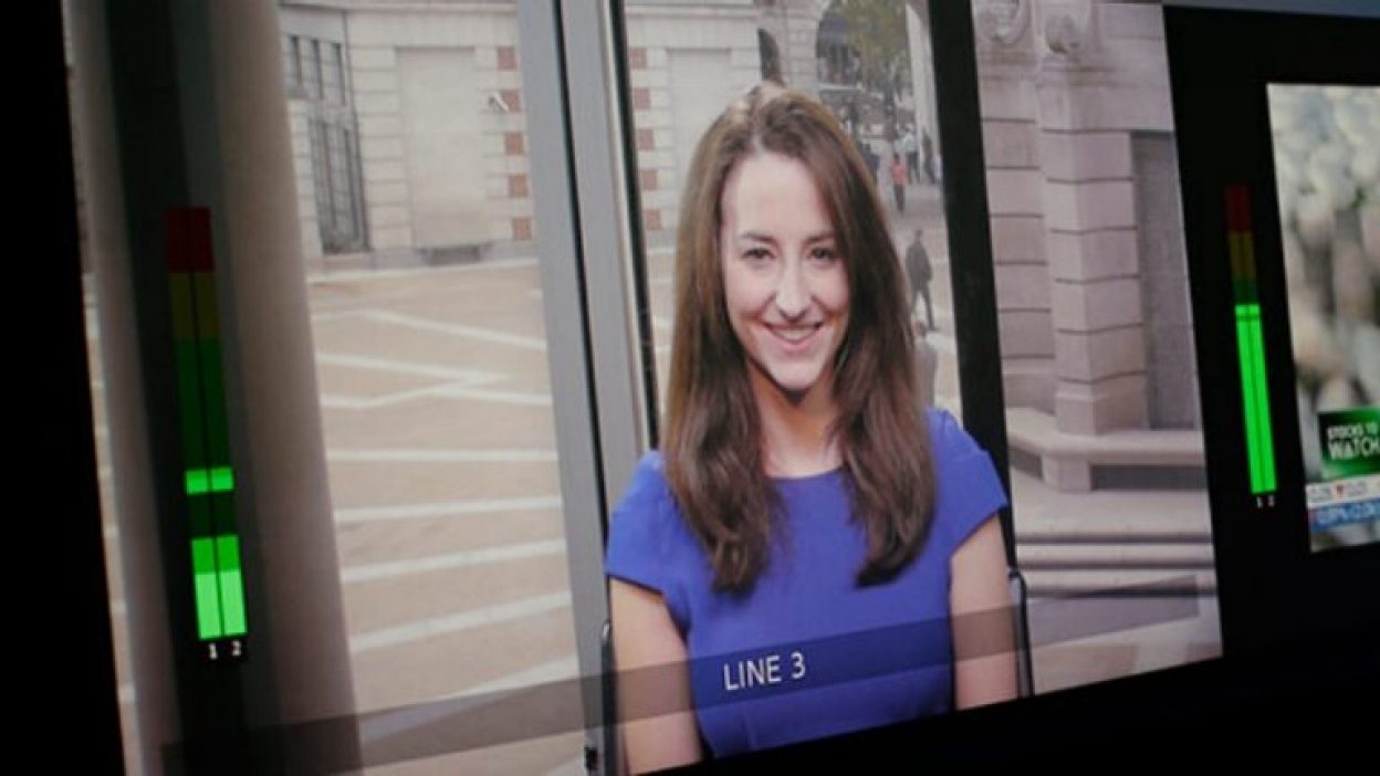 Woman in purple dress being filmed in studio 3