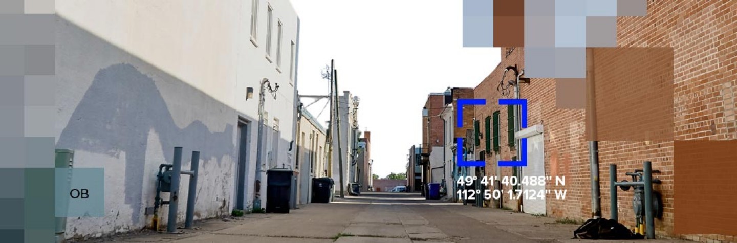 A camera view of a street zoning in on an area, representing KYC screening that highlights otherwise hidden information